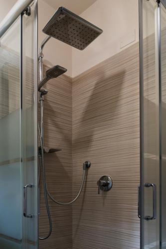 a shower with a shower head in a bathroom at Il Loto in Bologna