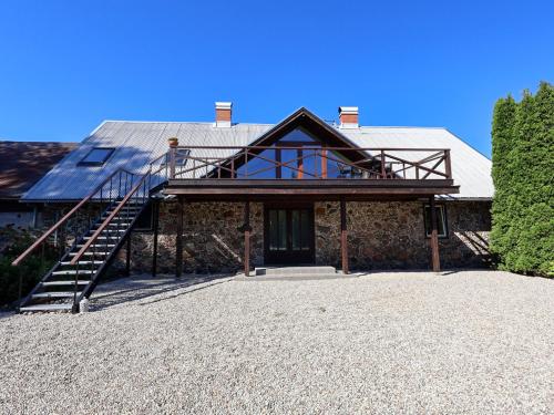 a house with a metal roof and a staircase at Aizpuri Park View in Nīca