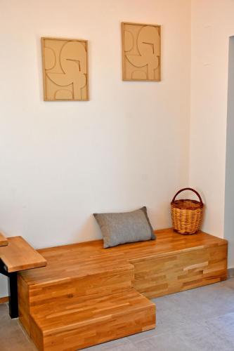 a wooden bench in a room with two pictures on the wall at Opuntia Boutique Hotel in Kalívia