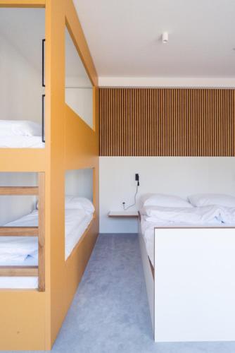 a room with two bunk beds and a desk at Hotel a Hostinec Slunce in Osečná