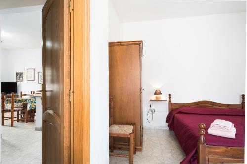 Ένα ή περισσότερα κρεβάτια σε δωμάτιο στο Posada porto trilocale