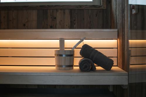 a cup and a drink sitting on a shelf in a sauna at Luf Lodges in Ischgl