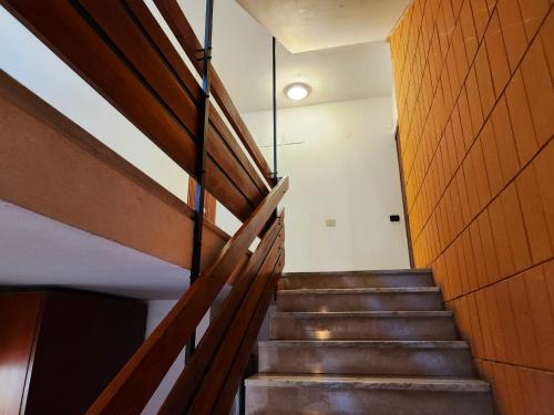 a staircase in a building with a wooden wall at Appartamento Limen in Marinella di Sarzana