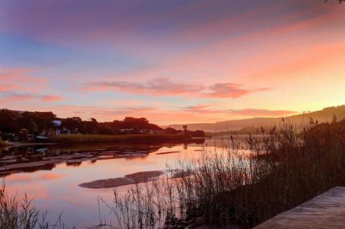 a view of a river at sunset at Cloverleigh Guest House in Wilderness