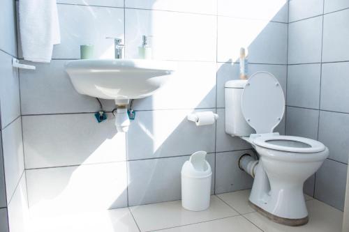 a bathroom with a toilet and a sink at Guest House Auasblick by State House in Windhoek