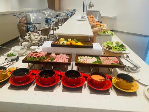 a buffet with many plates of food on a table at The KH Cam Ranh Nha Trang Beachside in Thôn Hòa Ða