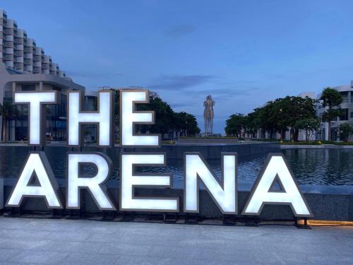 a sign that reads the arena in front of a building at The KH Cam Ranh Nha Trang Beachside in Thôn Hòa Ða