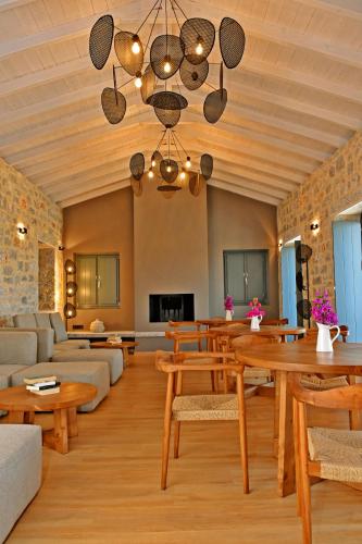 a living room with wooden furniture and a table at Opuntia Boutique Hotel in Kalívia