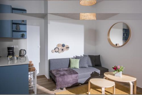 a living room with a couch and a table at Villa Roza by Prime Stay in Stalida