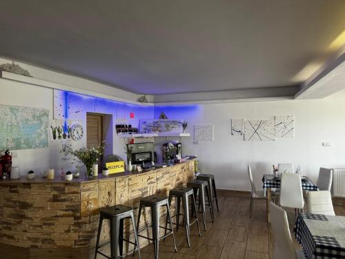 a restaurant with a bar with stools in a room at Chill Out Wygryny in Ruciane-Nida