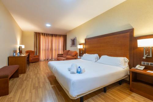 a hotel room with a large bed with towels on it at Moon Dreams Calabahía in Cala del Moral