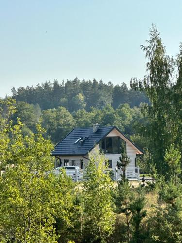 a house with solar panels on top of it at Mazurski Domek - Wake Up Home Ogonki in Ogonki