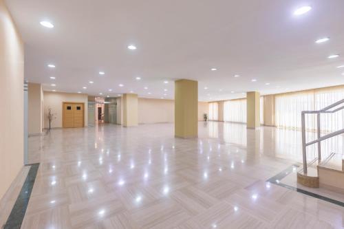 a large lobby with a wooden floor and a staircase at Moon Dreams Calabahía in Cala del Moral
