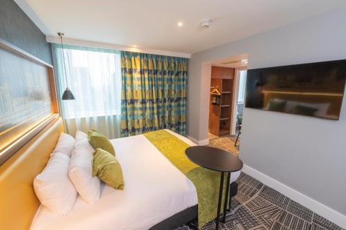 a hotel room with a bed and a window at ibis Styles Leeds City Centre Arena in Leeds