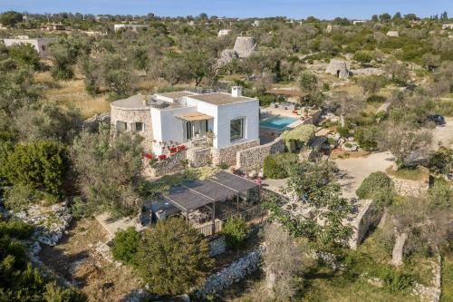 an aerial view of a house with a pool at Trullo Contessina in Torre Vado