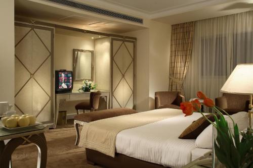 a hotel room with a bed and a desk at Sonesta Hotel Tower & Casino Cairo in Cairo