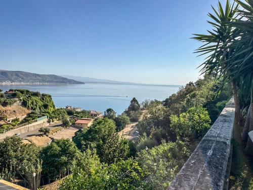 a view of the water from a hill with trees at Hssoverato in Soverato Marina