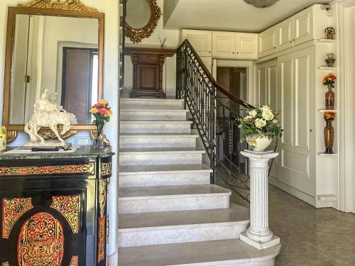 a staircase in a house with a mirror and flowers at Hssoverato in Soverato Marina