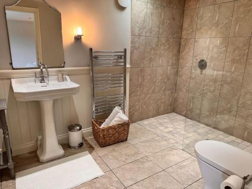 a bathroom with a sink and a toilet and a shower at Luxury Barn with sauna near York welcoming families, friends, groups in York