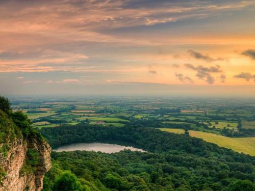 a view of a lake on the side of a mountain at Luxury Barn with sauna near York welcoming families, friends, groups in York