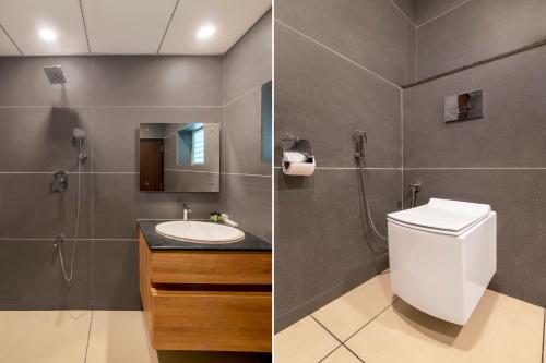 a bathroom with a toilet and a sink at Gateway Inn in Bangalore