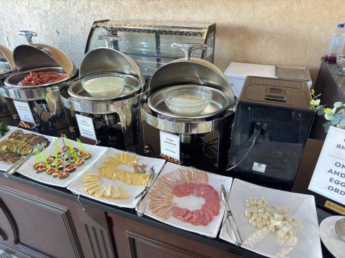 a buffet with many different types of food on a table at Hotel Sultan in Qarshi
