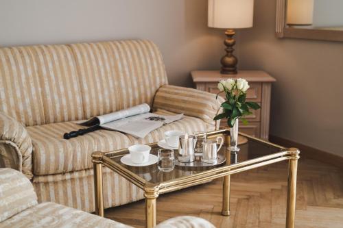 a living room with a couch and a coffee table at Hotel Adria in Merano