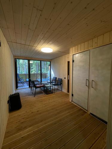 a room with a table and chairs on a wooden floor at Шишка in Bukovel