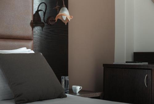 Una cama o camas en una habitación de Hotel Simeon