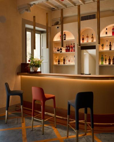 a bar with three chairs and a counter at La Monastica Resort & Spa in Borgo a Buggiano