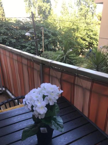 un vase de fleurs blanches assis sur un balcon dans l'établissement Charmant Studio proche du Centre-Ville, à Nice