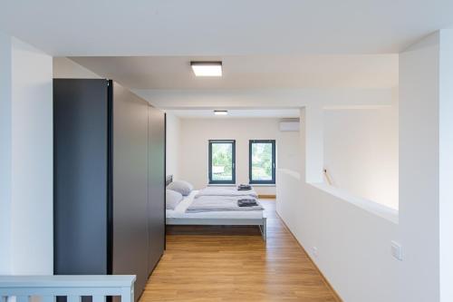 a bedroom with a bed and a hallway at Rezidence Novosadská in Olomouc