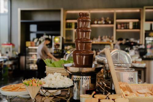 a kitchen with a counter with food on it at Richmann Resort Hotel Hatyai in Hat Yai