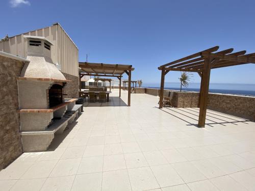 a patio with a pizza oven on the beach at Edificio Prieto VIV 7 in Puerto del Rosario