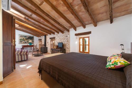 a bedroom with a bed and a living room at Sa Teulera de Pina in Pina