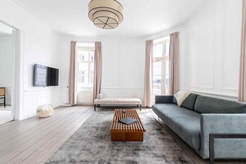 a living room with a couch and a table at Chic Apartment in Vibrant Area by Copenhagen Canals in Copenhagen