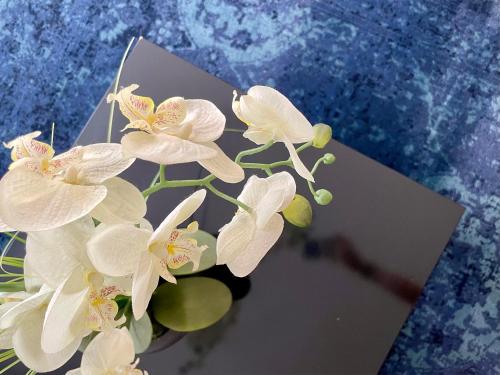 a bunch of white flowers in a vase on a table at Smart Hotel Budapest in Budapest