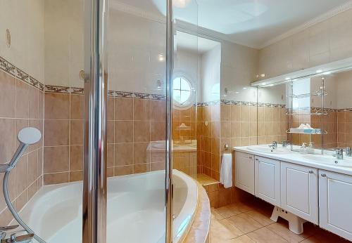 a bathroom with a shower and a tub and a sink at Stunning House 5-Bedrooms for 9P- 20min from Paris in Le Blanc-Mesnil