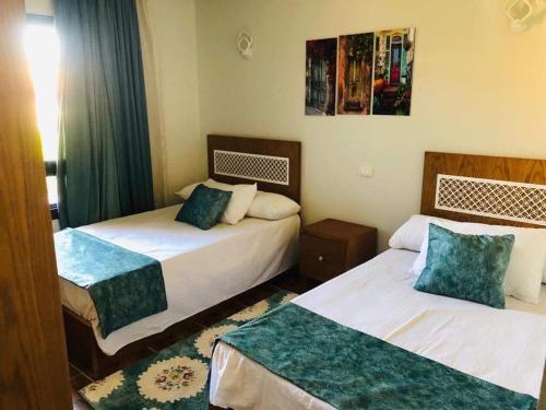 a hotel room with two beds in a room at فيلا الساحل الشمالى Villa North coast Marseilia Beach 3 " Families Only" in Alexandria