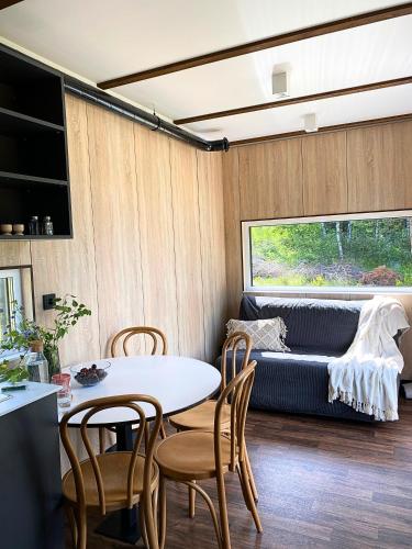 a living room with a table and chairs and a couch at Arche Siedlisko Miedwieżyki in Milejczyce