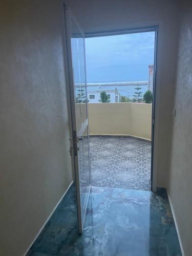 a glass door leading into a room with a view at Villa vue mere 3 chambre et 2 salon salle de fetes in Kenitra