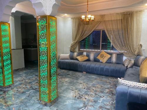 a living room with a couch and a window at Villa vue mere 3 chambre et 2 salon salle de fetes in Kenitra