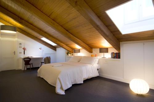 a bedroom with a large bed and a table at La Gensola In Trastevere in Rome