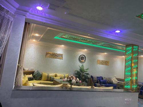 a living room with yellow couches and a large mirror at Villa vue mere 3 chambre et 2 salon salle de fetes in Kenitra