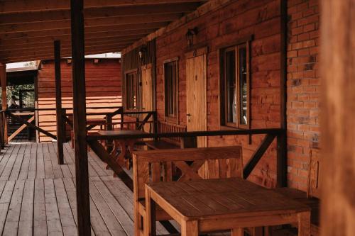 a wooden porch with benches and a building at BUBLA CITY RANCH in Kopřivnice