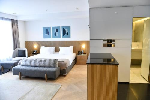 a hotel room with a bed and a chair at Faqra Hills Hotel in Kfardebian