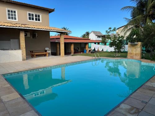 a swimming pool in front of a house at House Beach Canoa in Canoa Quebrada