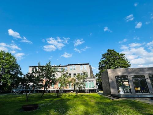a building with a grass field in front of it at Gutshaus Wohnung 1 in Laschendorf