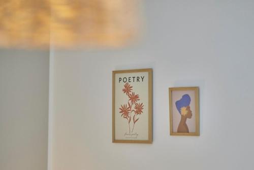 two pictures on a wall with the word potty at Neu!!! Moselbleibe Weingartenhaus in Bernkastel-Kues
