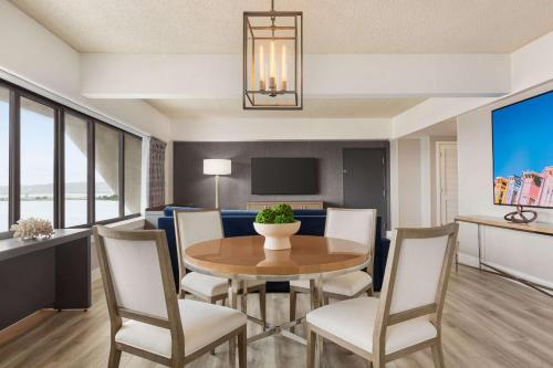 a living room with a dining room table and chairs at Hilton San Francisco Financial District in San Francisco
